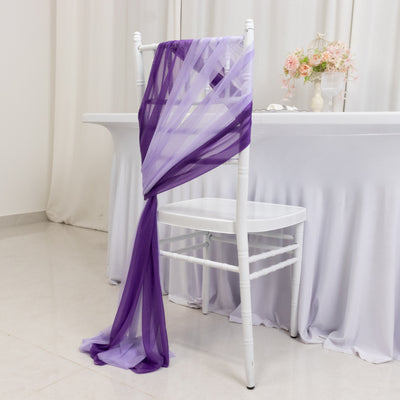 Purple chiffon chair sash elegantly draped on a white chair in a decorated setting.