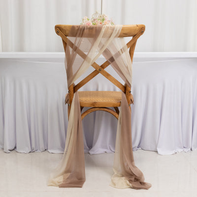 Elegant wooden chair draped with soft, sheer fabric in neutral tones.