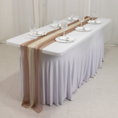 Elegant banquet table set with glasses and decorative runners.