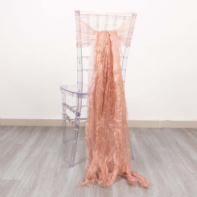Pink textured fabric draped over a clear acrylic chair.