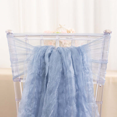 Light blue sheer fabric draped on a clear chiavari chair.