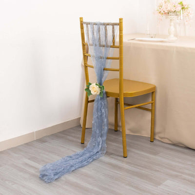 Blue chair sash with flower decoration draped on a gold chiavari chair.