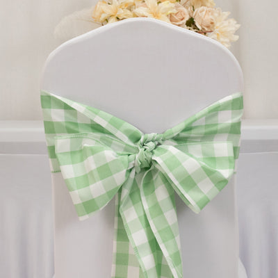 Green gingham chair bow decoration on a white chair.