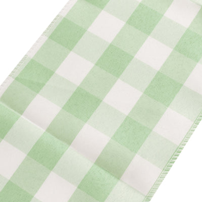 Green and white gingham fabric roll on a plain background