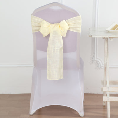 Transparent chair cover with yellow satin bow on a plain backdrop.