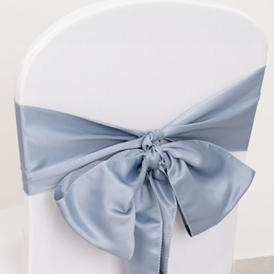 Light blue satin chair sash tied in a bow on a white chair.