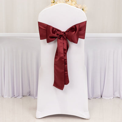 White chair cover with burgundy satin bow.