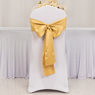 White chair cover with yellow satin bow, elegantly styled for events.