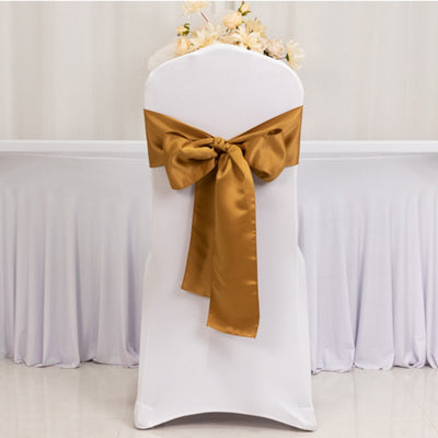 White chair cover with gold satin ribbon bow.