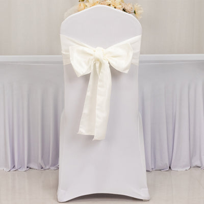 White chair cover with a large satin bow, ideal for weddings and events.