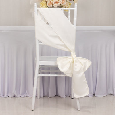 Elegant cream satin chair sash tied in a bow, perfect for weddings or events.