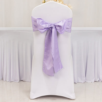 White chair cover with a lavender satin bow.
