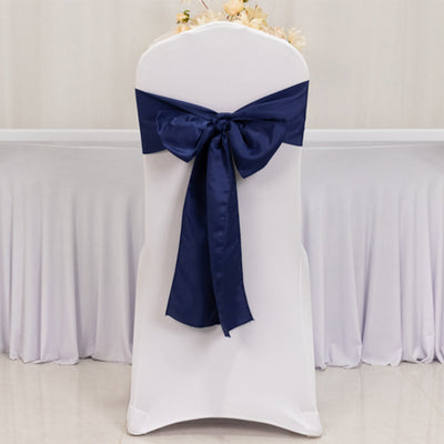 White chair cover with navy blue satin bow decoration.