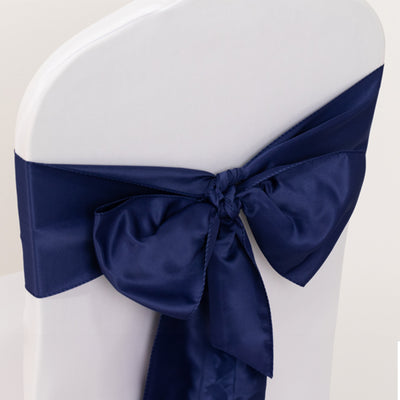 Navy satin chair sash with bow on a white chair
