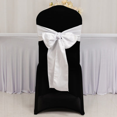 Black chair with a white satin bow, perfect for elegant events.