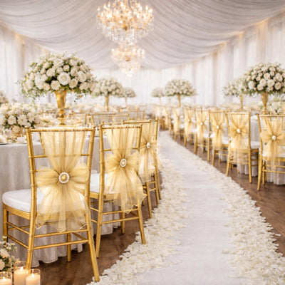 Elegant wedding reception with gold chairs and floral decor.