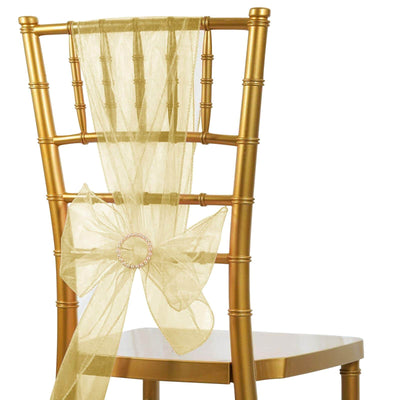 Gold chiavari chair with a sheer yellow sash and bow.