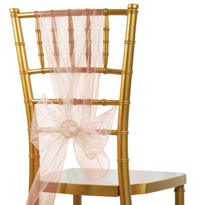 Gold chiavari chair with a pink organza sash bow.