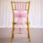 Gold chair with a pink organza sash and flower embellishment.
