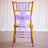 Gold chair with a purple tulle bow and floral accent.