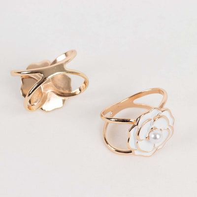 Gold flower ring with pearl detail, elegant design.