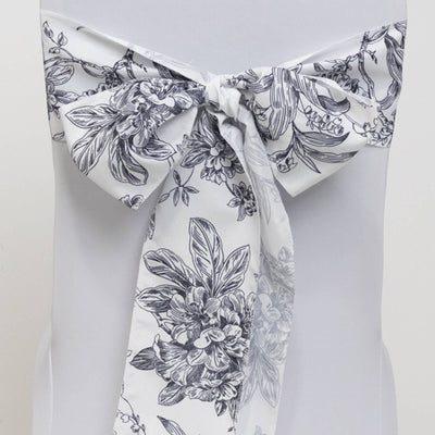 Floral print chair sash in black and white tied in a bow.