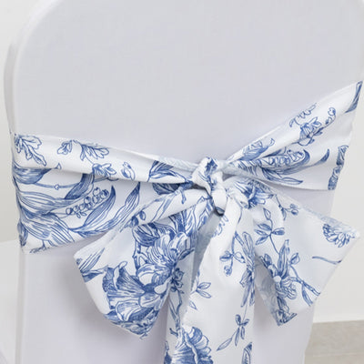 Blue floral chair sash tied in a bow on a white chair.