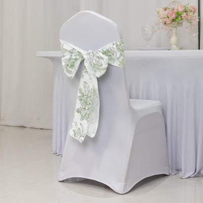 White chair cover with green floral bow on a decorated chair in a banquet setting.