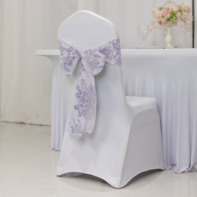 White chair cover with lavender floral bow for event decoration.
