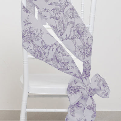 Purple floral patterned satin ribbon tied around a white chair.