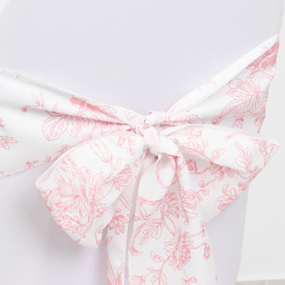 Floral bow tie detail on a white fabric backdrop.
