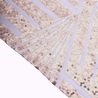 Sequin fabric with a geometric design in soft pastel colors.