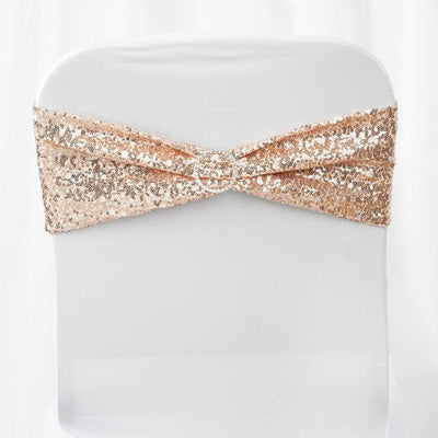 Rose gold sequined chair sash with decorative buckle on white chair.