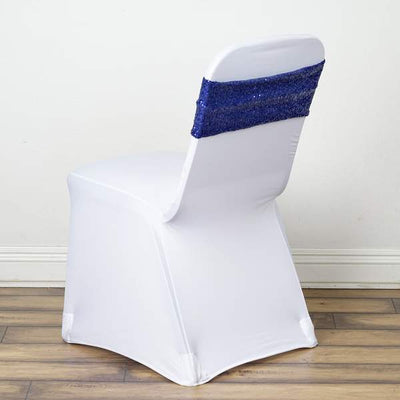 White chair cover with blue sequined back, ideal for event decor.