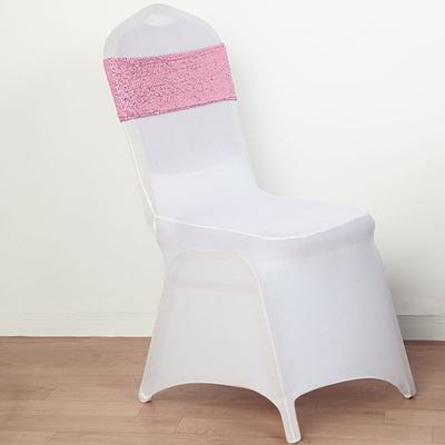 White chair with pink sequin sash on a plain background.