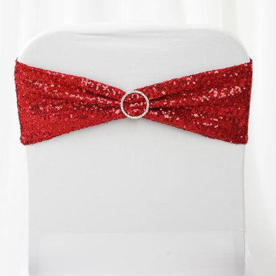 Red sequin chair sash with rhinestone buckle on a white chair