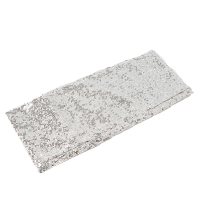 Silver sequin fabric roll on a plain white background