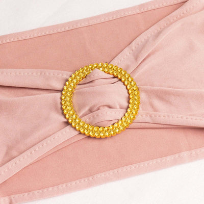 Pink fabric with a gold beaded circular embellishment.