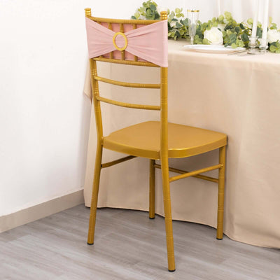Gold chiavari chair with pink sash at an elegantly set table.