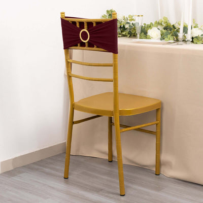 Gold chiavari chair with burgundy sash against a neutral backdrop.