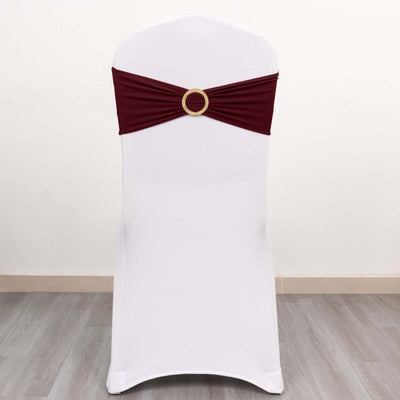 Maroon chair sash with decorative ring on a white chair.