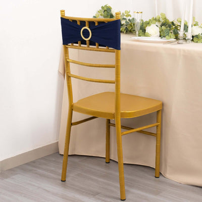 Gold chiavari chair with navy blue sash against a neutral table setting.