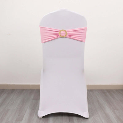 White chair with a pink sash and decorative ring