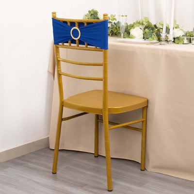 Gold chiavari chair with blue sash at a table setting.
