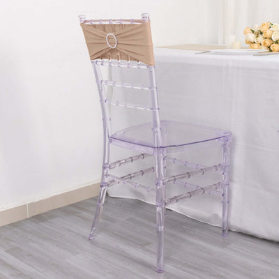 Transparent acrylic chair with a decorative backrest.