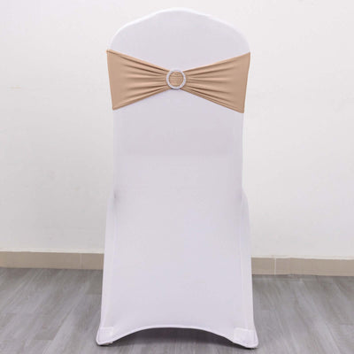 White chair cover with beige sash and decorative ring