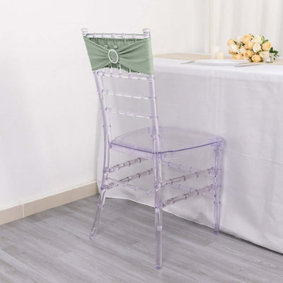 Clear acrylic chair with green sash, perfect for elegant events and decor.