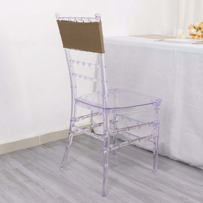 Clear acrylic chair with a brown seat cushion