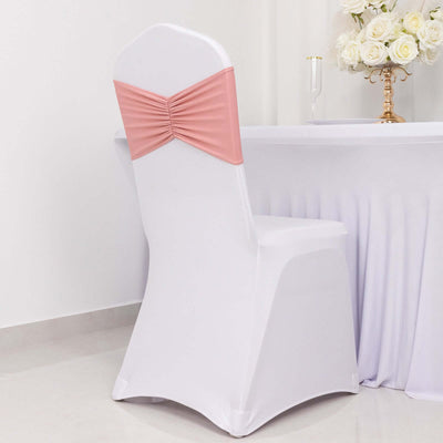 White chair with pink satin bow on back, styled for events.