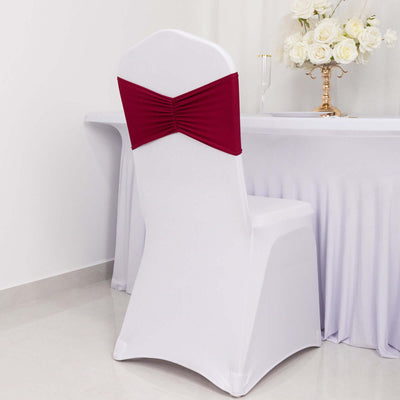 White chair with burgundy sash in a decorated setting.
